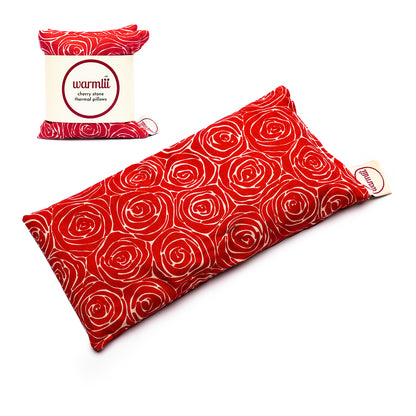 natracare warmlii cherry stone thermal pillow showing red fabric laid out on white background